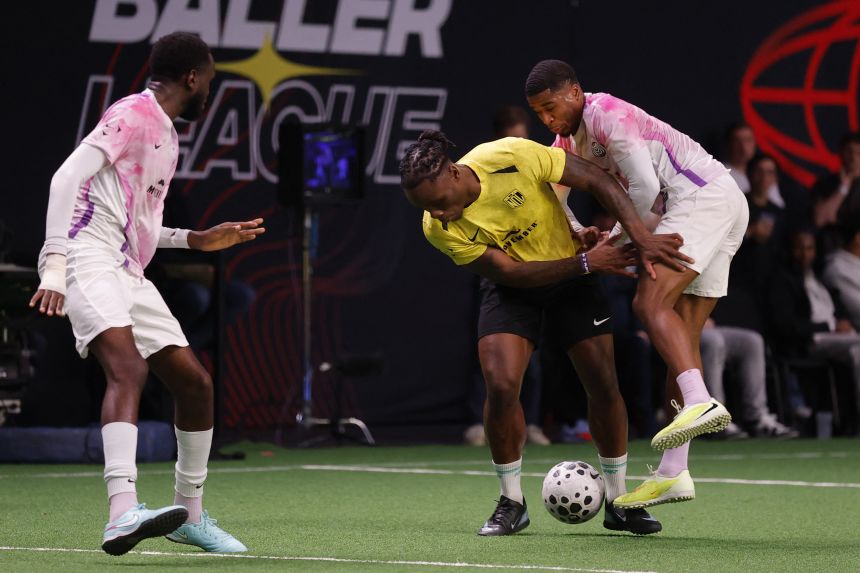 NDL FC's Razzaq Coleman, center, competes with MVPs United's Montel McKenzie during a Baller League match in December.
