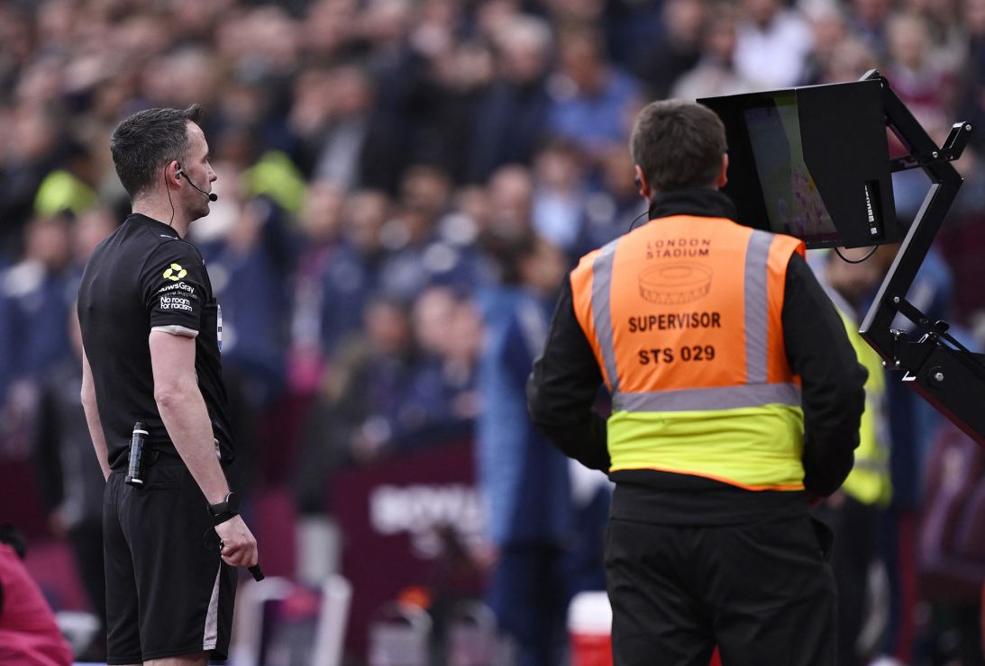 Referee Chris Kavanagh looks at the VAR monitor before disallowing West Ham's goal.