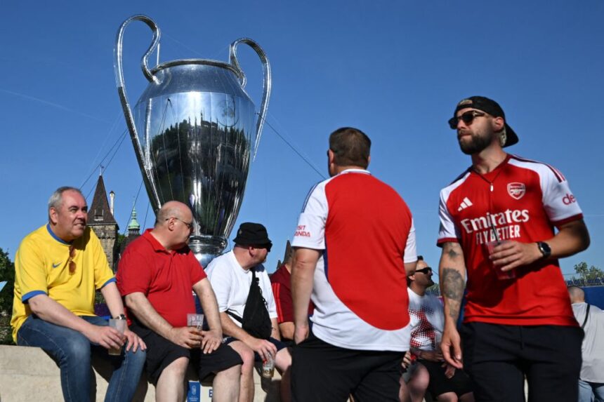 Arsenal fans hang out in Budapest, Hungary, near a giant replica of the Champions League trophy on Friday.