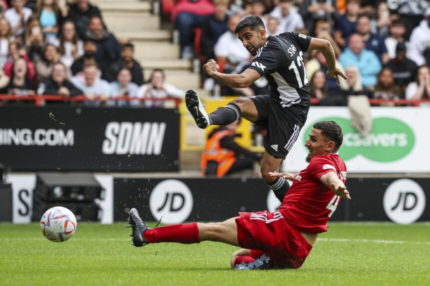 Vikram Singh Barn, also known as Vikkstar123, scores during the annual Sideman Charity Match in 2022.