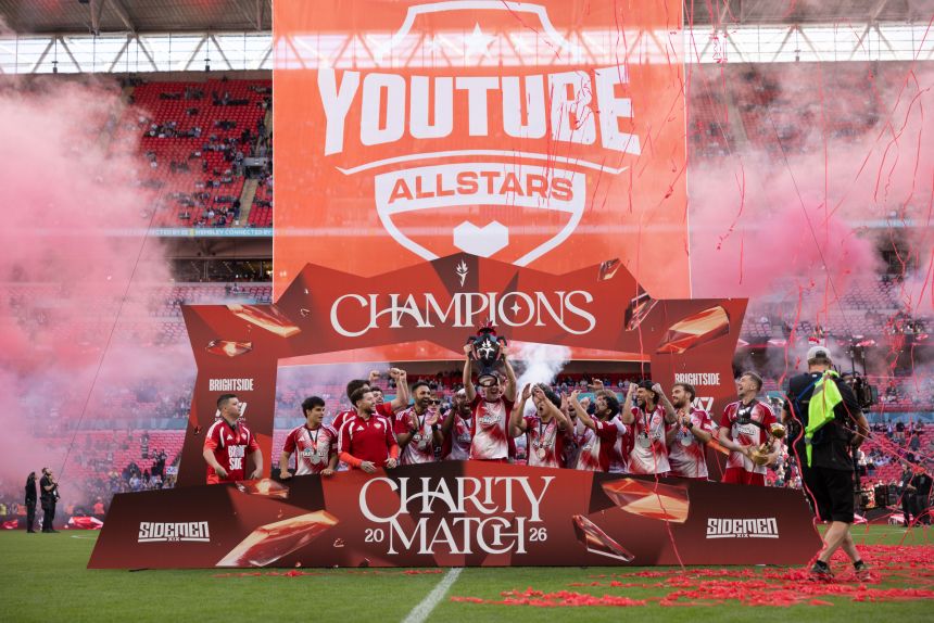 The YouTube Allstars raise the trophy after winning this year's Sidemen Charity Match at Wembley Stadium.