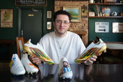 Jordan Dawson displays some of the boots he has designed.