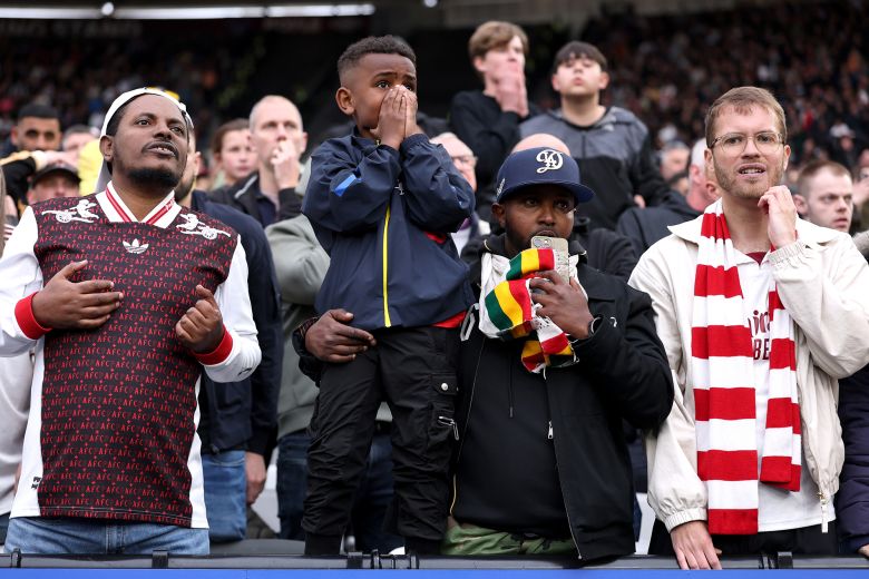 Arsenal fans react during the VAR review.