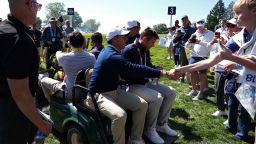 NEWTOWN, PENNSYLVANIA - MAY 12: Rory McIlroy of Northern Ireland interacts with fans as he leaves the course in a cart during a practice round prior to the PGA Championship at Aronimink Golf Club on May 12, 2026 in Newtown, Pennsylvania. (Photo by Emilee Chinn/Getty Images)