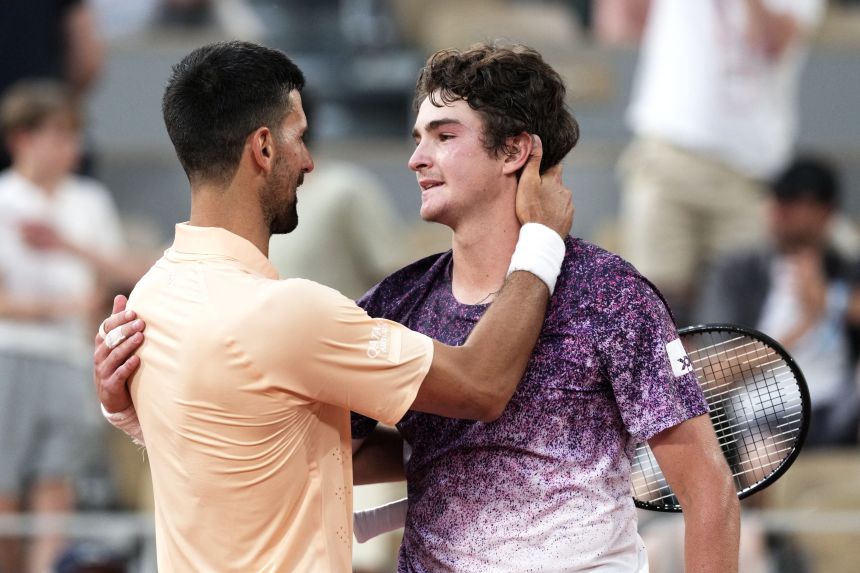 Novak Djokovic congratulates João Fonseca after the match.