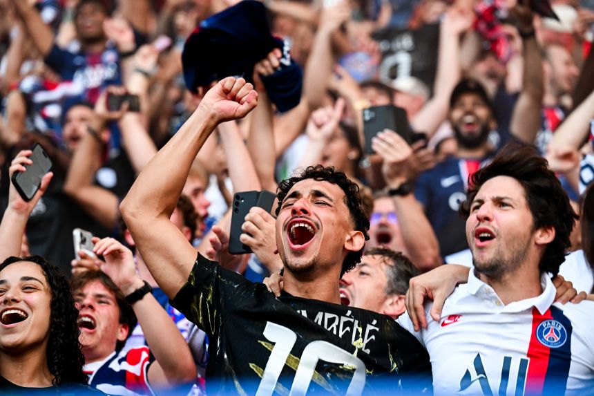 Fans of PSG during the Champions League final watch at the Parc des Princes in Paris, France.