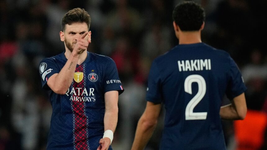 PSG's Khvicha Kvaratskhelia celebrates with Achraf Hakimi after scoring his side's fourth goal during the Champions League semifinal first leg soccer match between Paris Saint-Germain and Bayern Munich in Paris, Tuesday, April 28, 2026. (AP Photo)