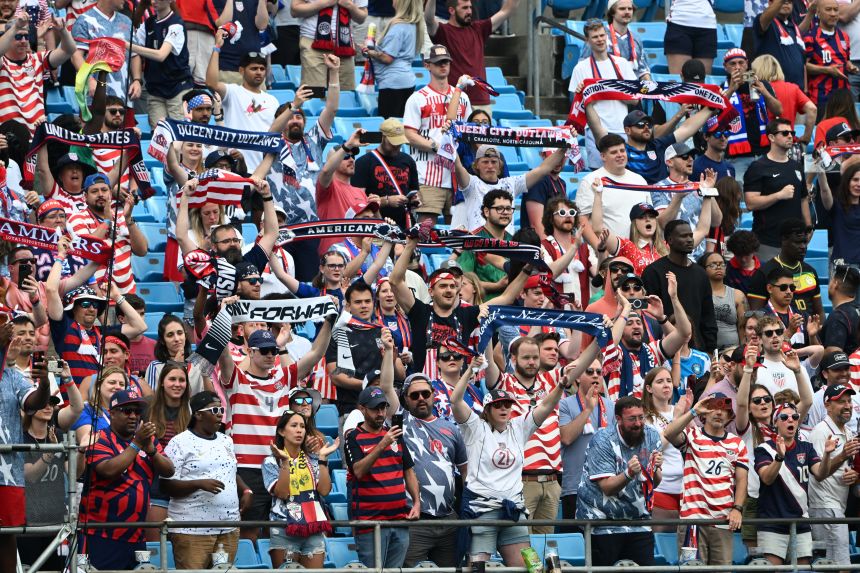US fans hold their scarves high after the win against Senegal on May 31.