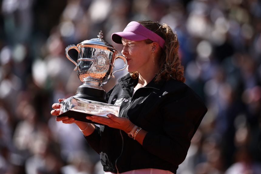 Russia's Mirra Andreeva celebrates with the trophy after winning her first grand slam title.