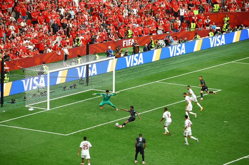 Canada's Jonathan David scores against Qatar.