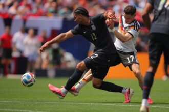 USMNT's Miles Robinson, left, battles Germany's Florian Wirtz for the ball during Saturday's friendly in Chicago.