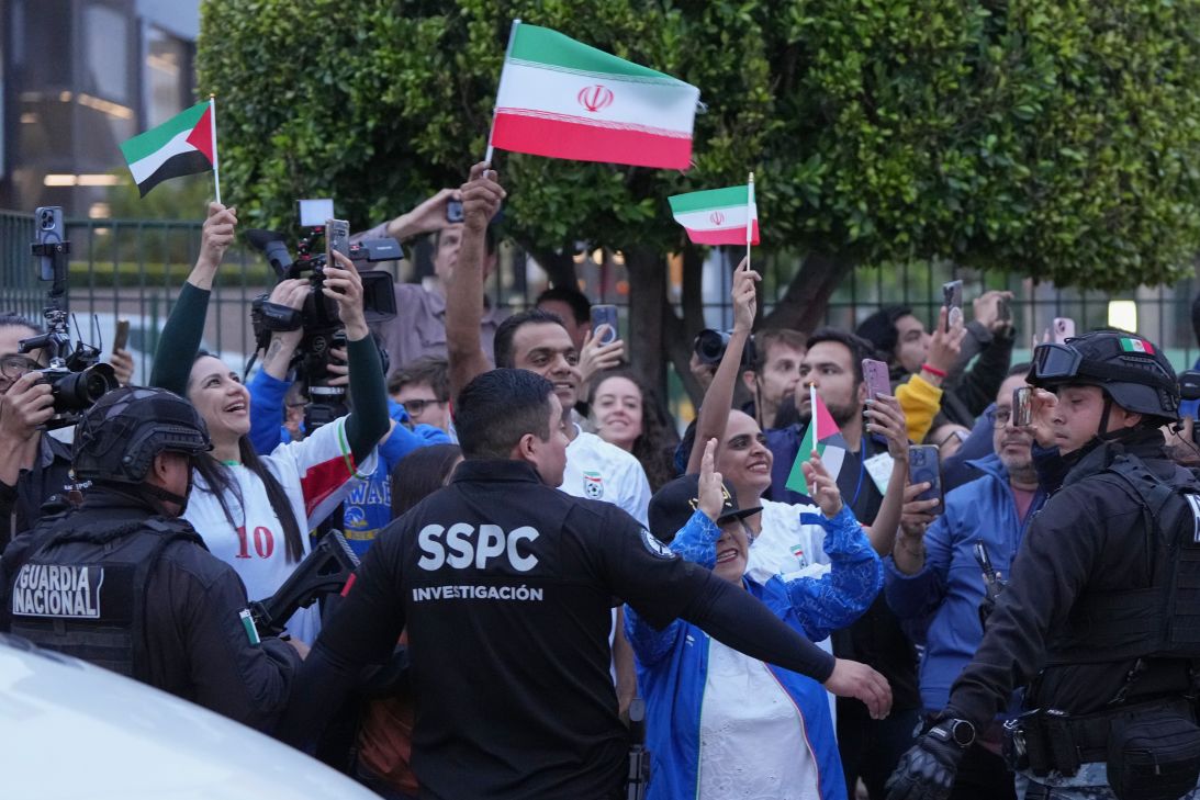 Fans of Iran's soccer team wave as players arrive in Tijuana, Mexico, on Sunday.