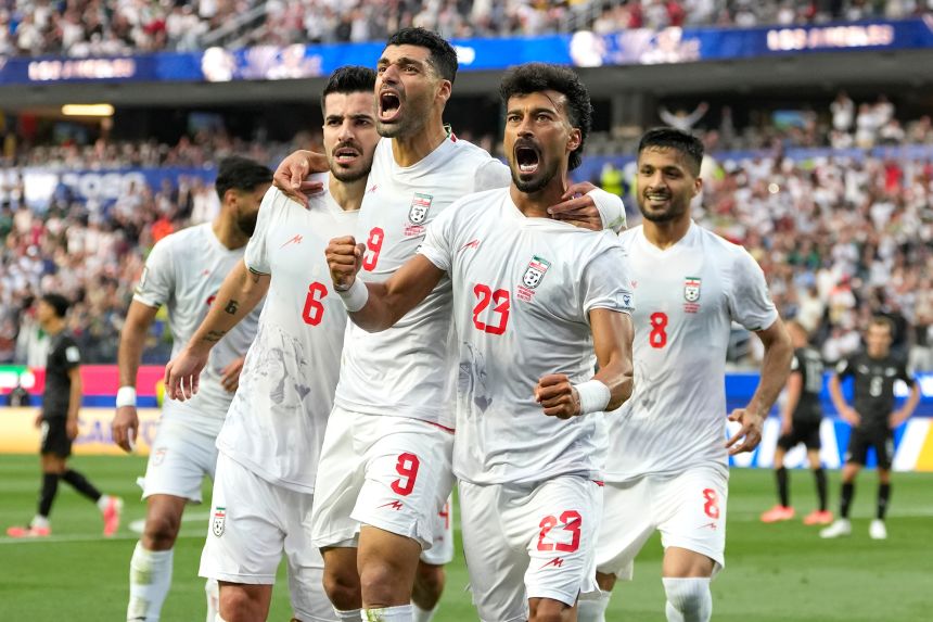 Iran's Ramin Rezaeian celebrates with his teammates after scoring a goal during the World Cup Group G soccer match between Iran and New Zealand Monday.