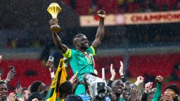 Senegal players celebrate with the trophy after winning the Africa Cup of Nations (CAN) final football match against Morocco at the Prince Moulay Abdellah Stadium in Rabat on January 18, 2026.