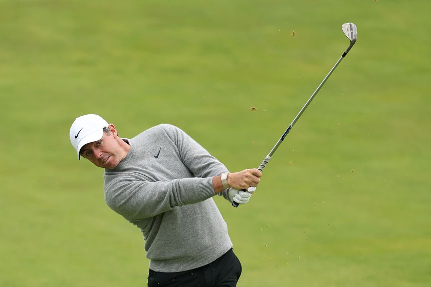 Rory McIlroy of Northern Ireland plays a shot on the 14th hole and finishes tied for ninth after the first round.