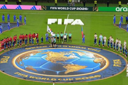 When the time came for the national anthems to be played, the full squads of both teams, including the substitutes, stood around the centre circle facing each other (AP Photo)