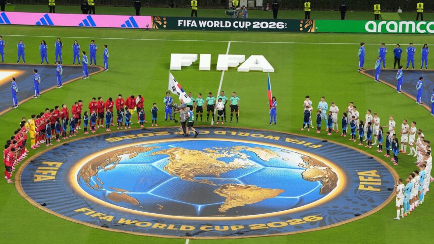 When the time came for the national anthems to be played, the full squads of both teams, including the substitutes, stood around the centre circle facing each other (AP Photo)
