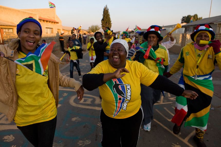 Fans dance during half-time of the opening 2010 World Cup match between South Africa and Mexico.