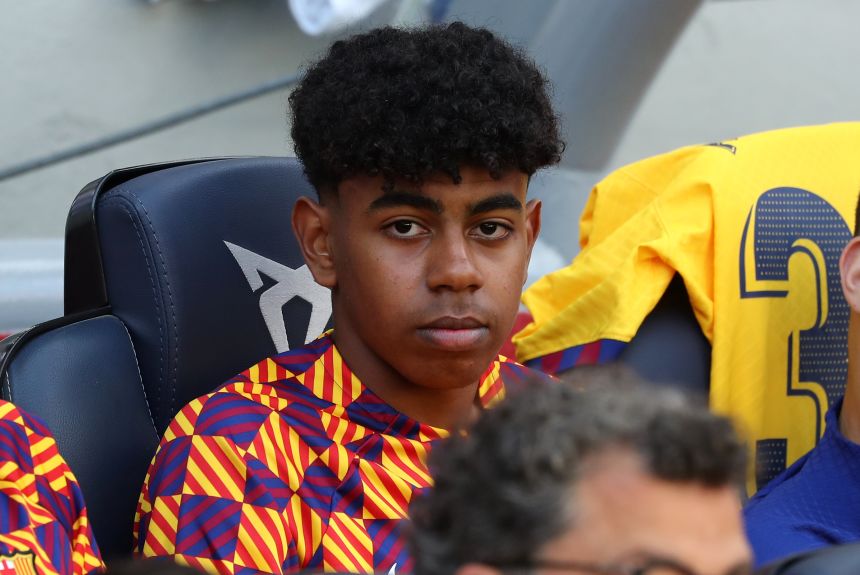 Yamal watches from the bench during a La Liga match in April 2023.