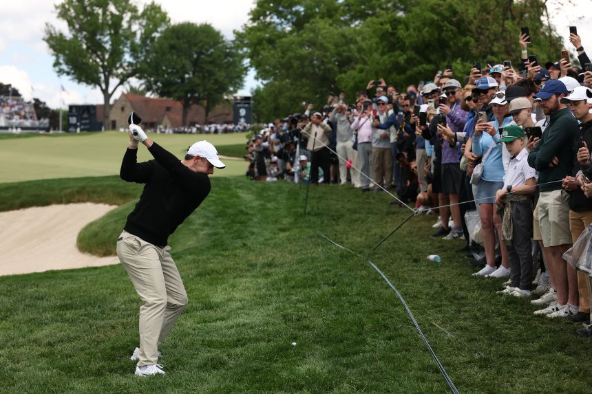 Fans watch Rory McIlroy hit a shot at the PGA Championship last month.
