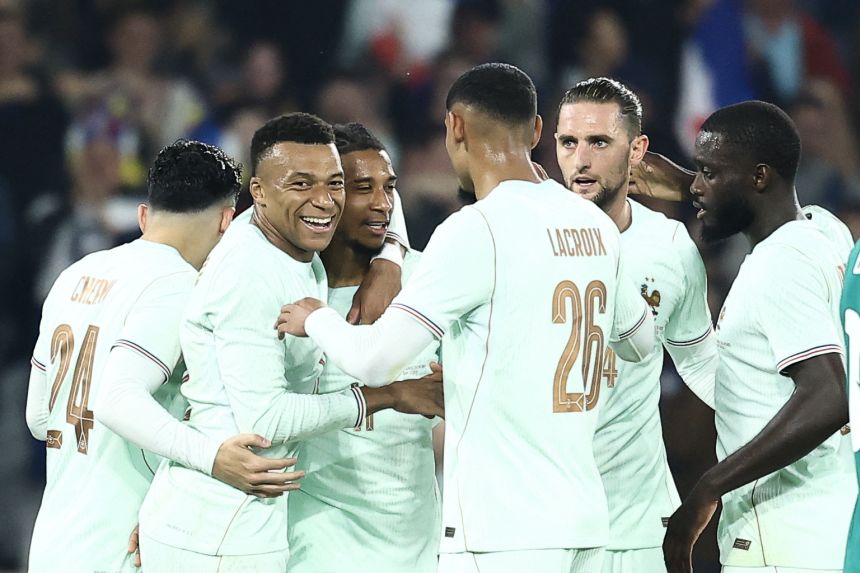 France players celebrate with Michael Olise, third from left, after he completed a hat-trick with an incredible solo effort in a friendly win over Northern Ireland on Monday.