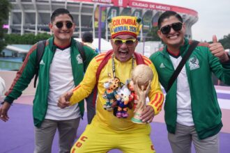 Fans pose for photos outside of the stadium in Mexico City on Tuesday.