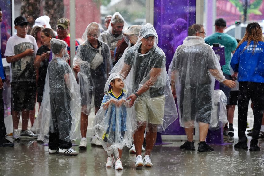 Fans in the rain as the kick-off for England's final World Cup warm-up match against Costa Rica gets delayed due to stormy weather in Orlando, Florida, on June 10.