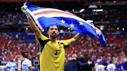 Cape Verde goalkeeper Vozinha holds up the nation's flag after the 0-0 draw with Spain on Monday.