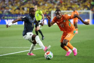 Ecuador's John Yeboah, left, and Ivory Coast's Yan Diomande both wear pink cleats during a World Cup match in Philadelphia.