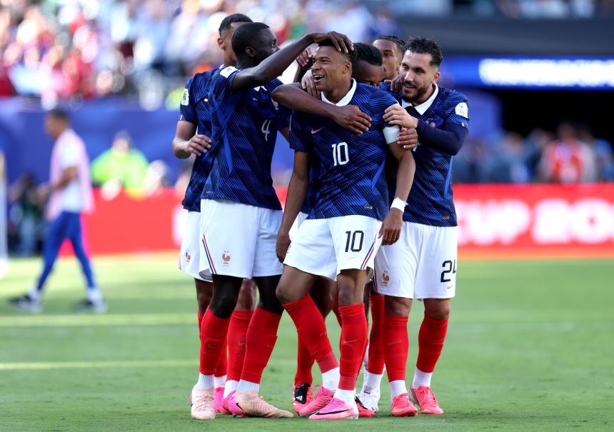 Kylian Mbappé celebrates with his France teammates after scoring a goal against Senegal.