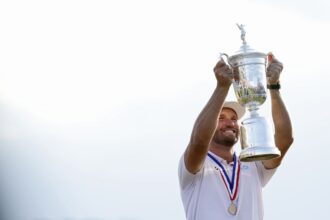 Wyndham Clark celebrates winning the US Open at Shinnecock Hills Golf Club on Sunday.