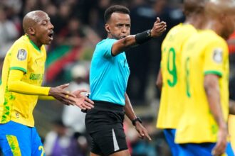 Somali referee Omar Artan, center, signals a penalty during the CAF Champions League final soccer match between AS FAR Rabat and Mamelodi Sundowns, in Rabat, Morocco, Sunday, May 24, 2026. (AP Photo/Mosa'ab Elshamy, File)
