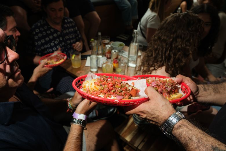 A waiter delivers food to a table at Socceria.