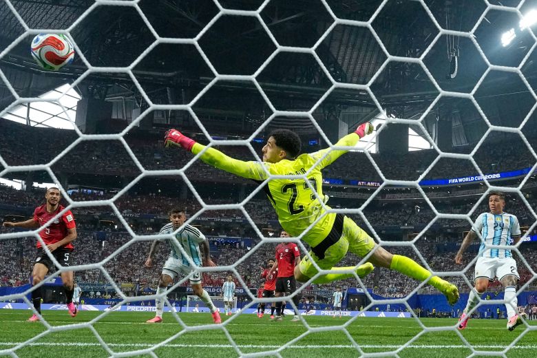 Argentina's Cristian Romero scores their opening goal.