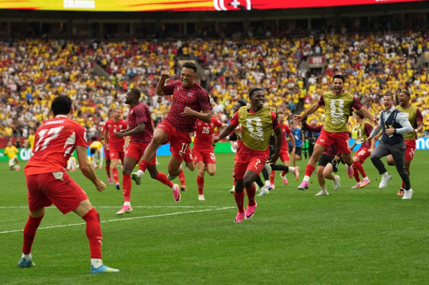 Swiss players celebrate after winning ihe penalty shootout.