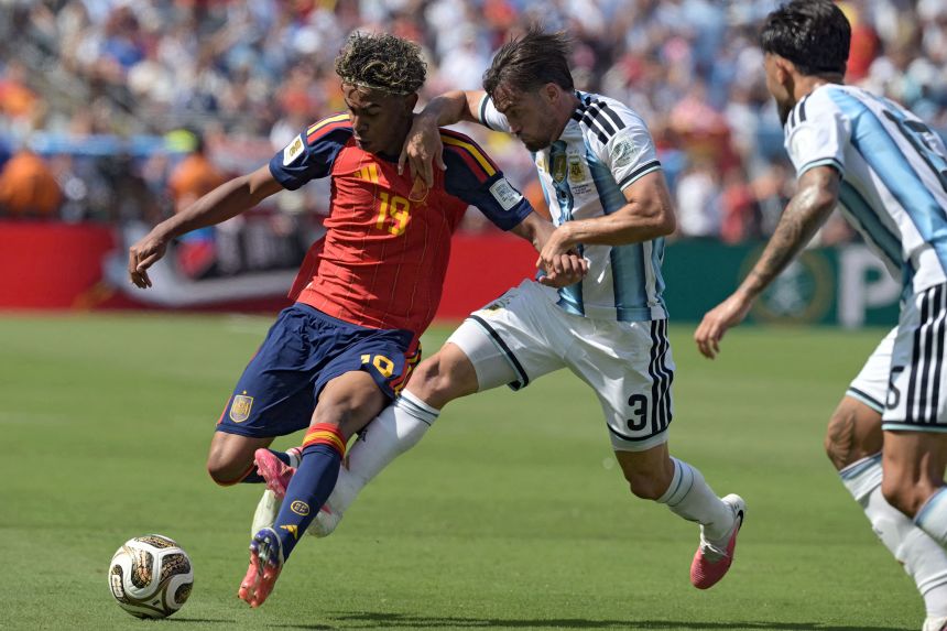 Lamine Yamal, Spain's sensational teenage winger, is defended by Argentina's Nicolás Tagliafico during Sunday's final.