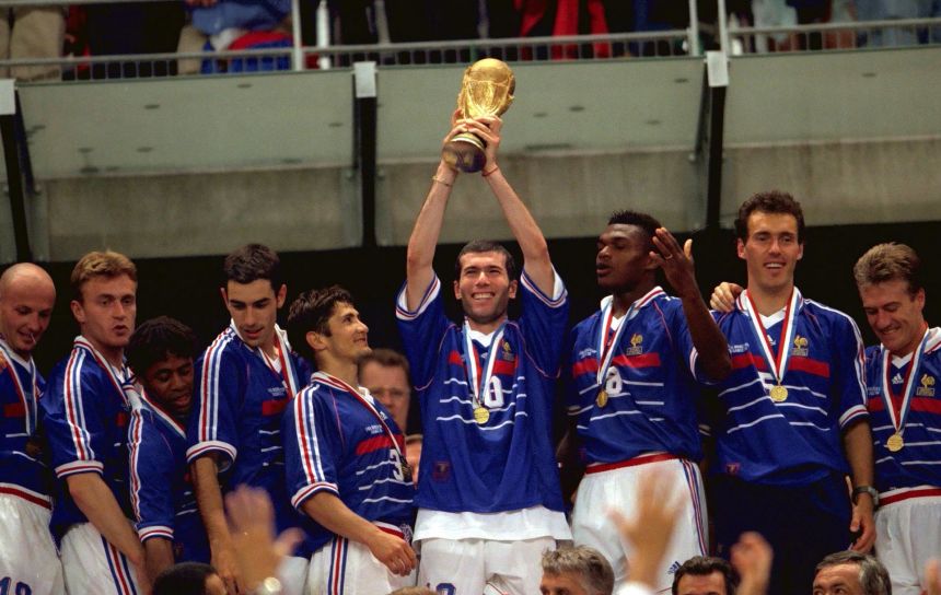 Zidane lifts the World Cup trophy after scoring two goals in the 1998 final versus Brazil.