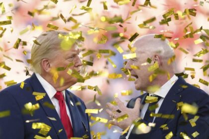 President Donald Trump, left, speaks with FIFA President Gianni Infantino as confetti falls after the conclusion of the 2026 World Cup final.