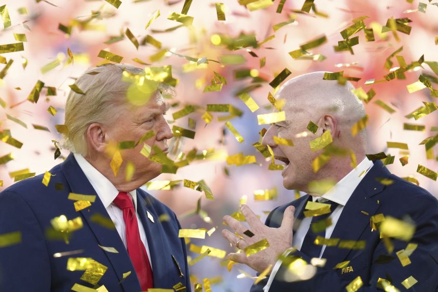 President Donald Trump, left, speaks with FIFA President Gianni Infantino as confetti falls after the conclusion of the 2026 World Cup final.