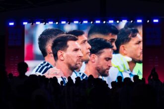 A giant screen shows Argentina's forward #10 Lionel Messi and other teammates as fans gather at a fan festival to watch the World Cup quarterfinal football match between Argentina and Switzerland in Kansas City, Missouri, on July 11.