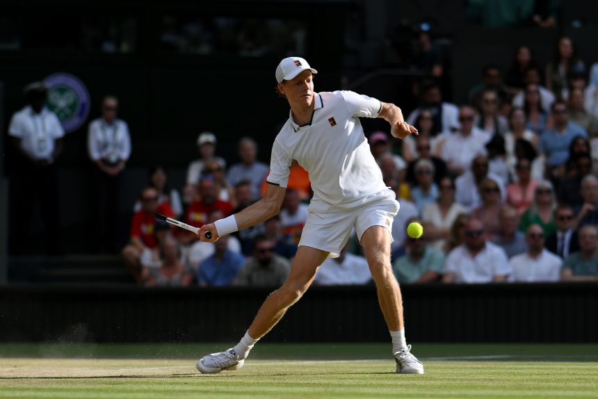 Jannik Sinner hits a forehand against Novak Djokovic during their semifinal match on day twelve of Wimbledon.