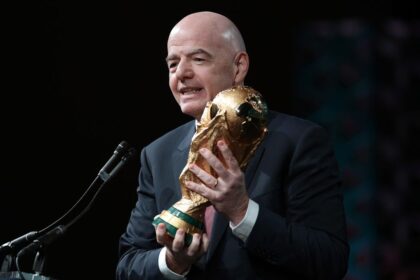 FIFA President Gianni Infantino holds the FIFA men's World Cup Trophy as he addresses the winter meeting of the US Conference of Mayors on January 29 in Washington, DC.