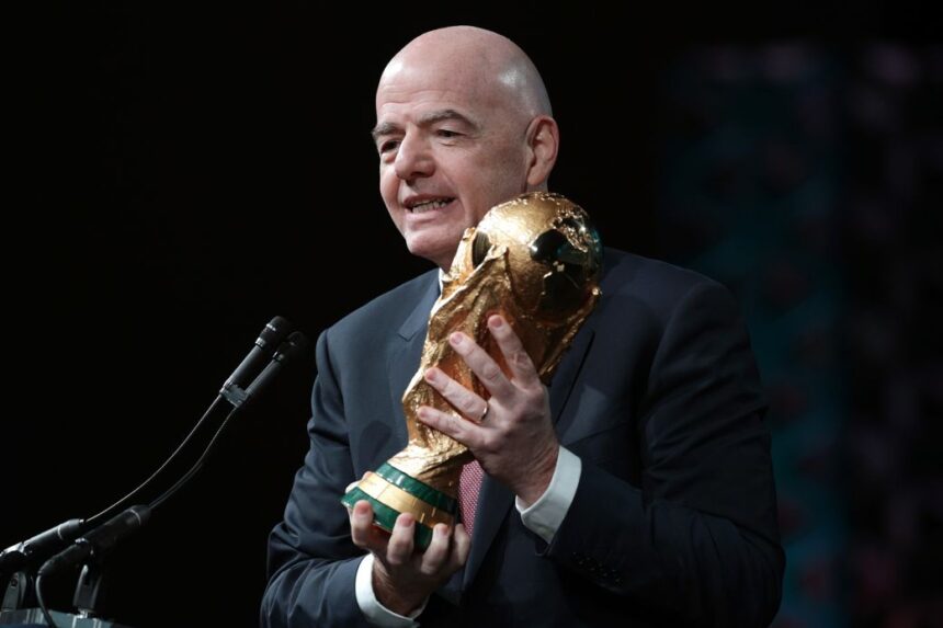 FIFA President Gianni Infantino holds the FIFA men's World Cup Trophy as he addresses the winter meeting of the US Conference of Mayors on January 29 in Washington, DC.