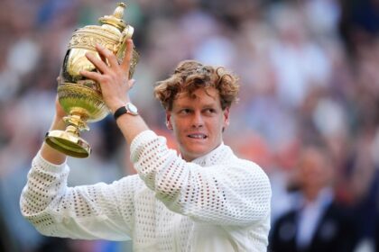 Jannik Sinner of Italy lifts the trophy after defeating Alexander Zverev of Germany in the Wimbledon men's singles final in London.