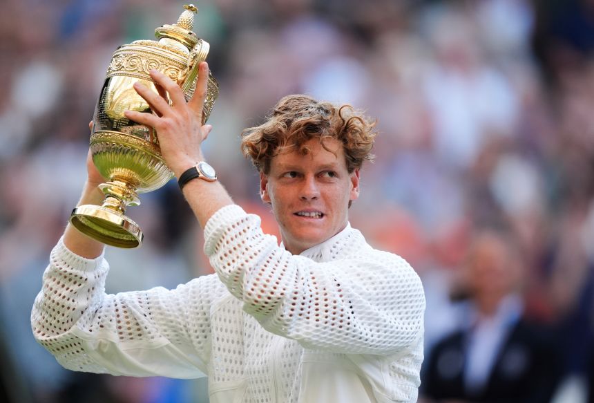 Jannik Sinner of Italy lifts the trophy after defeating Alexander Zverev of Germany in the Wimbledon men's singles final in London.
