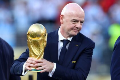 FIFA president Gianni Infantino holds the World Cup trophy after the final between Spain and Argentina on July 19.