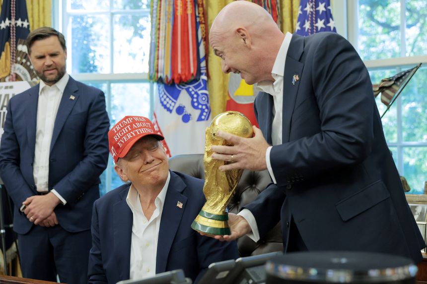 Infantino shows Trump the men's World Cup Trophy in the Oval Office as Vice President JD Vance looks on.
