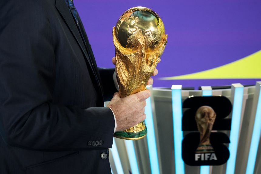 FIFA President Gianni Infantino holds the FIFA World Cup trophy following the 2026 FIFA World Cup European Play-Off draw at the FIFA's Home of Football in Zurich on November 20, 2025.